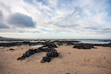 Rocky coast of northern Lanzarote at low tide on a cloudy day