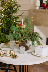 Festive table for christmas with spruce glasses and candles