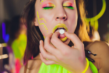 beautiful girl with lsd on tongue in nightclub with pink smoke.