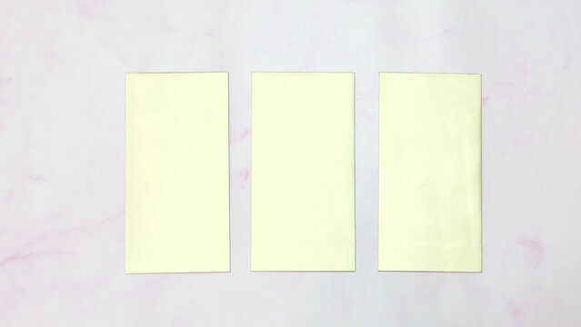 Three blank golden rectangle cards displayed side by side, with a marble background.