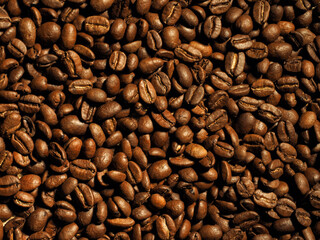 Antique vintage retro bronze coffee mill on black wooden board with roasted coffee beans