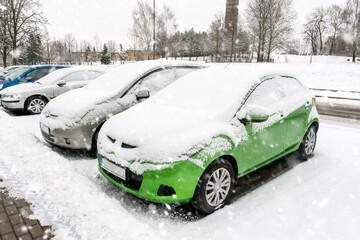 Parking lot with cars covered in snow