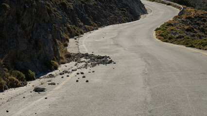 Rockfall - rocks fallen from a rocky cliff on the road