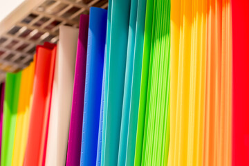 Back to school background. Rainbow colors of plastic document folders at stationery shop
