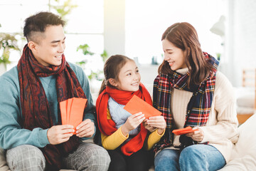 happy chinese new year. asian family giving red envelope for lucky at home