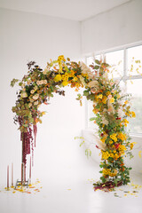 arch for the ceremony at the autumn wedding indoors