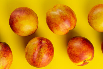 Ripe nectarine on a yellow background. Fresh fruits.