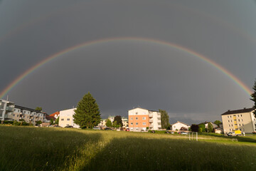 Shining Rainbow Over Residential Houses In The Country - Portrait