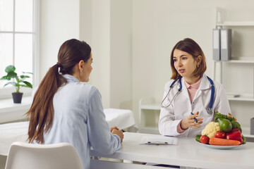 Female nutritionist makes a healthy diet plan for a patient who has come for nutrition advice....