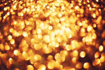 Glitter Bokeh gold color shimmer shinny glow background.