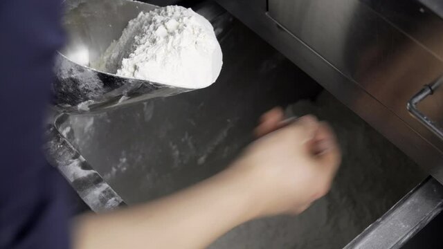 Scoop flour by hand