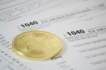 Bitcoin and alternate cryptocurrencies coin symbol on tax form, crypto currency sign, future technology financial concept
