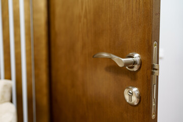 Obraz premium Wooden door with metal door handle and lock