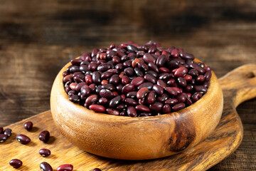 Red beans. Raw red beans in a wooden bowl on a brown wooden table. Organic Natural Vegetarian product