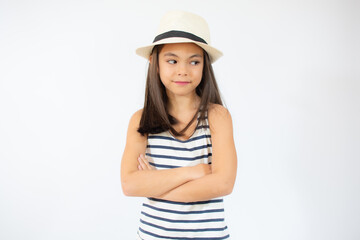 Fototapeta premium Enjoying vacation. Good vibes. Beach style. Little beauty in straw hat. Portrait of happy cheerful girl in summer hat over white background.