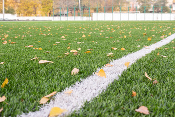 Artificial turf football field with white painted sports markings, outdoor activities concept