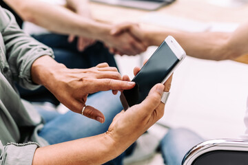 close up. a business woman uses a smartphone during a work meeting.