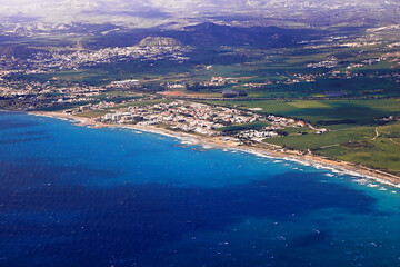 Fototapeta na wymiar View from an airplane of island of Cyprus. Seacoast line with blue Mediterranean sea