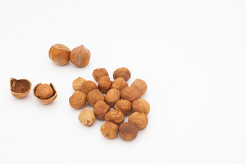 pile of hazelnut hazelnuts in shell and peeled isolated on white background