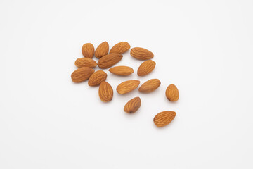 a pile of almond seeds isolated on a white background