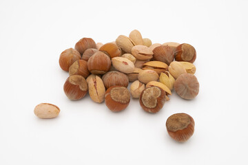 assorted hazelnuts and pistachios in shell isolated on white background