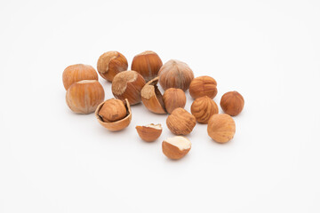 pile of hazelnut hazelnuts in shell and peeled isolated on white background