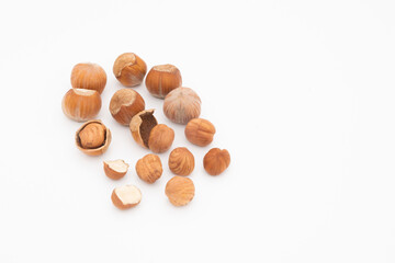 pile of hazelnut hazelnuts in shell and peeled isolated on white background