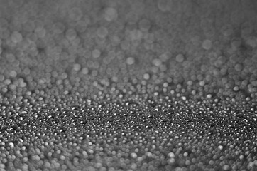 Crystal drops of water on a black background. Black background with water drops, selective focus.