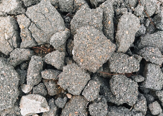 Texture, background of the destroyed, old, cracked in pieces of gray asphalt. Road works,...