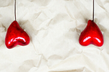 Two hearts on a crumpled beige background. Valentine's day background. 