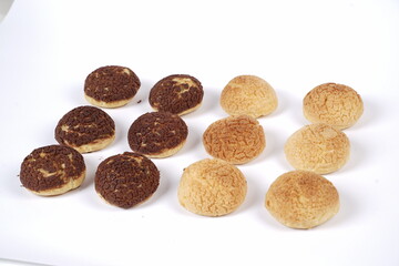 French traditional Choux pastry ball. Choux with  filling chantilly cream. Fresh golden profiterole or Pate a choux. Selective focus. Cream Puffs, choco vanilla Choux isolated on white background. 
