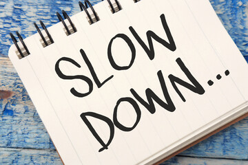 Slow Down, text words typography written on book, life and business motivational inspirational concept
