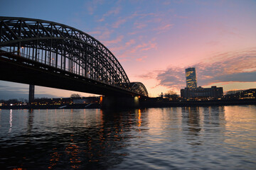 bridge over calm water, skyline, twilight
