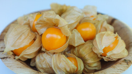 Organic cape gooseberry fruit (Physalis peruviana) in betel palm plate