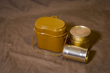
military bowler hat and canned food on army cloth