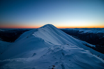 Fototapeta na wymiar Breathtaking winter sunset landscape at high altitude with colored sky