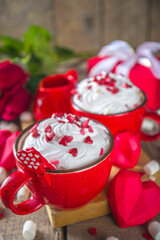 Valentine hot chocolate or coffee, Two red cups with hot chocolate or latte drink, with whipped cream ans sugar heart sprinkles, with roses bouquet ad gift box