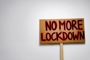 Protestive placard against coronavirus lockdowns against wall