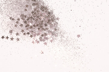 Fototapeta na wymiar Glitter and glittering stars on light gray background in vintage colors