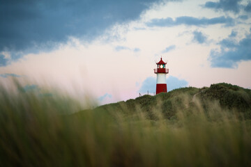 Fototapeta na wymiar Lighthouse on Sylt island Germany during colorful sunset with clouds no. 2