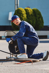 The plumber prepares to fix the problem in the sewer. Repair work on troubleshooting.