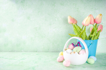 Happy Easter concept with easter eggs in basket and spring flowers. Easter background with copy space and photo frame. Happy Easter  greeting card background