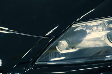  front xenon turning headlights of modern car in garage