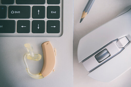 Hearing aid lying on a laptop