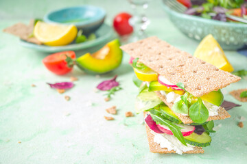 Healthy rye bread sandwiches with crispy bread, cream cheese and fresh spring vegetables