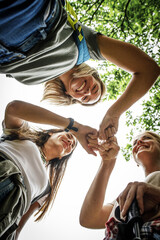 Group of female friends joying in nature and fresh air.They holding hands all for one. 