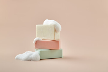 pieces of soap on a beige background - obrazy, fototapety, plakaty