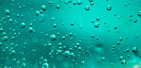 oil drops on water on blue background