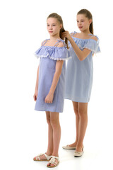 Twin Sisters in Identical Light Dresses, Girl Braiding her Siste
