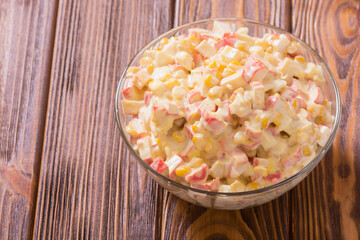 Salad with crab sticks , corn , eggs and mayonnaise